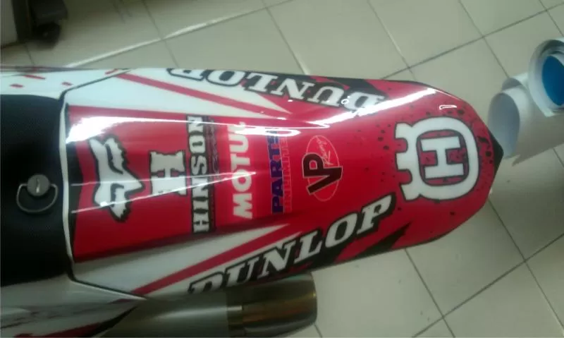 A dirtbike tail wrapped with General Formulations MotoMark advertising the Husqvarna Logo